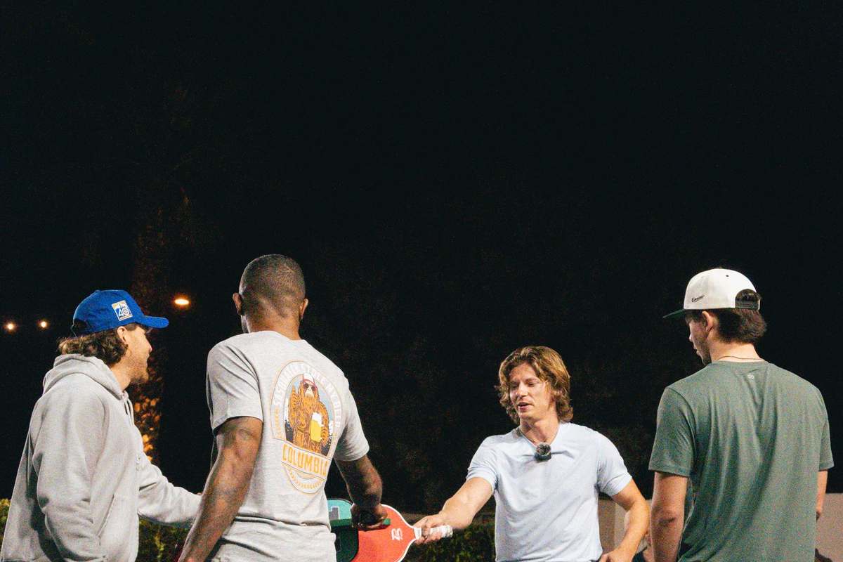 Pickleball court in use after dark under LED court lighting