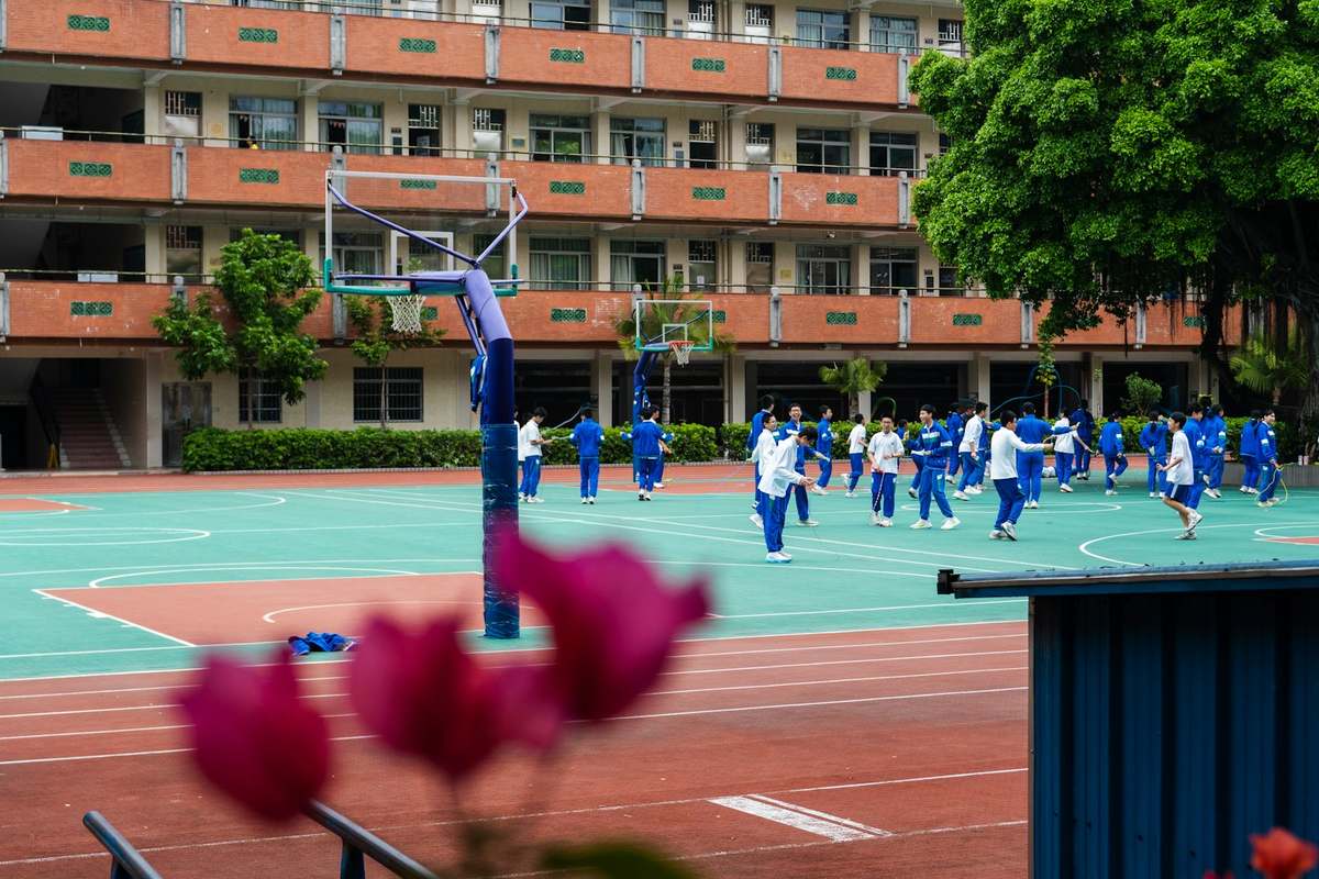Students playing on a school court with painted markings
